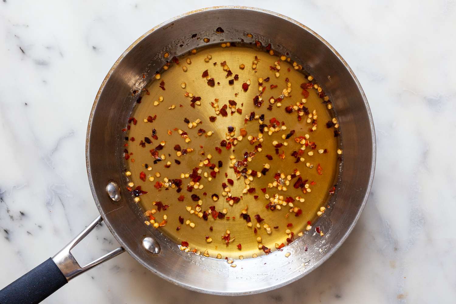 Making hot honey in a skillet to make Sheet Pan Hot Honey Roasted Shrimp and Broccoli.