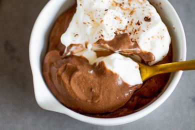 spoonful of chocolate pudding lifted from a bowl with more