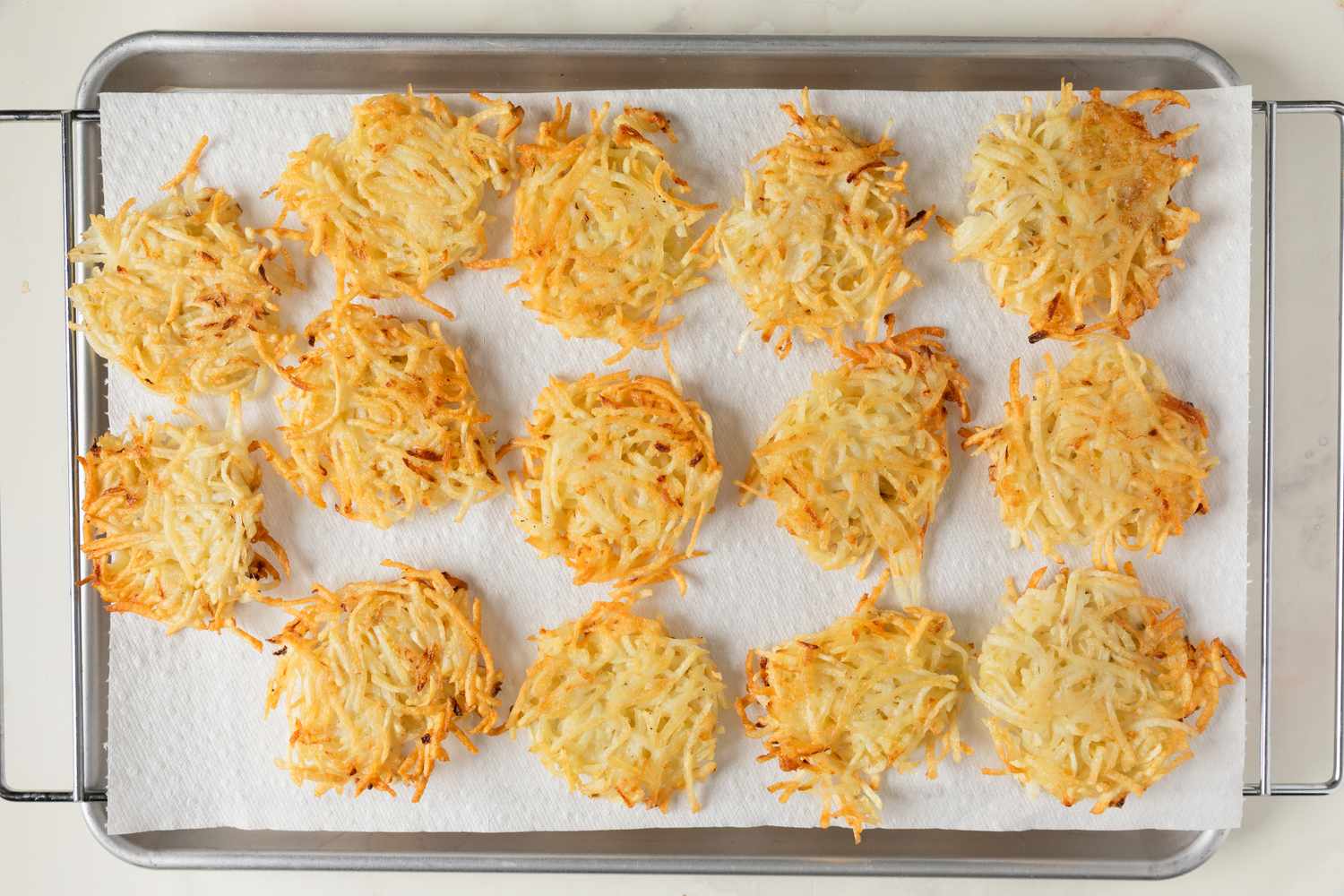 Latkes on a baking sheet lined with paper towels