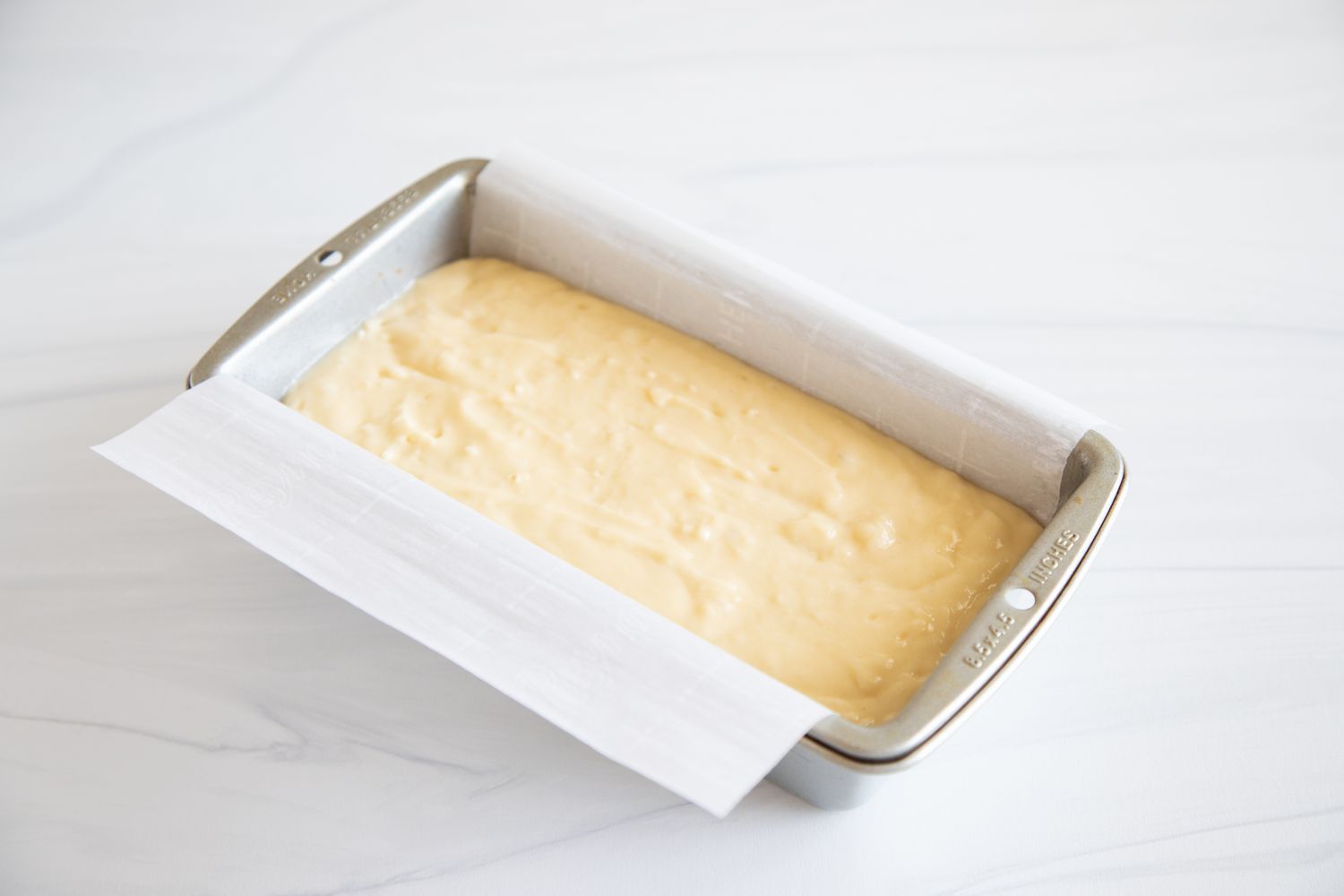 Batter in a loaf pan to make a Yogurt Cake Recipe.