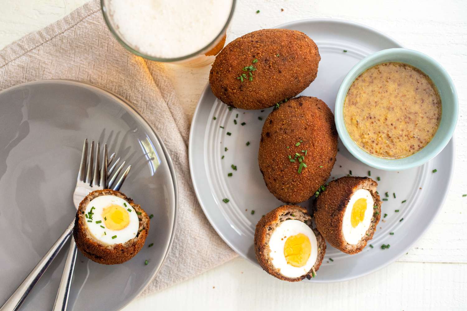 Scotch eggs served with honey mustard sauce and beer. 