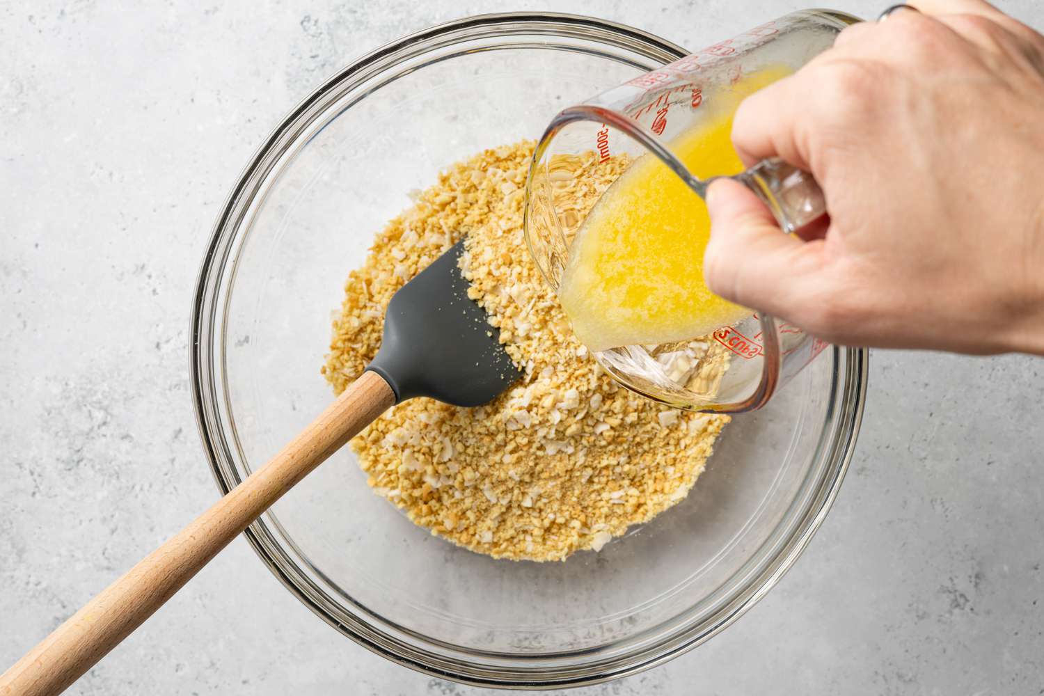 Melted Butter Added to Crushed Vanilla Wafers for Piña Colada Pie Crust 