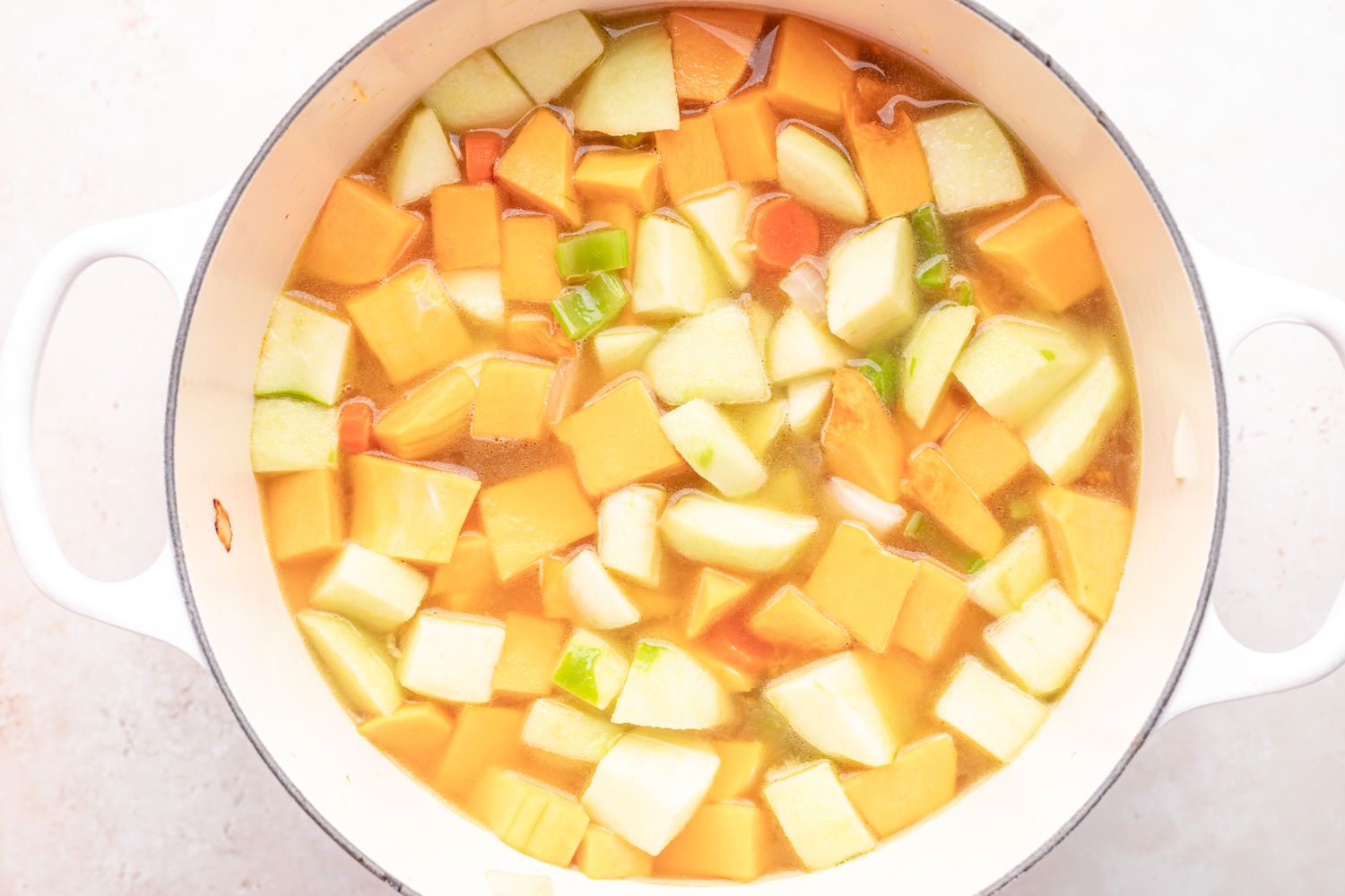 Making butternut squash soup recipe in a dutch oven.