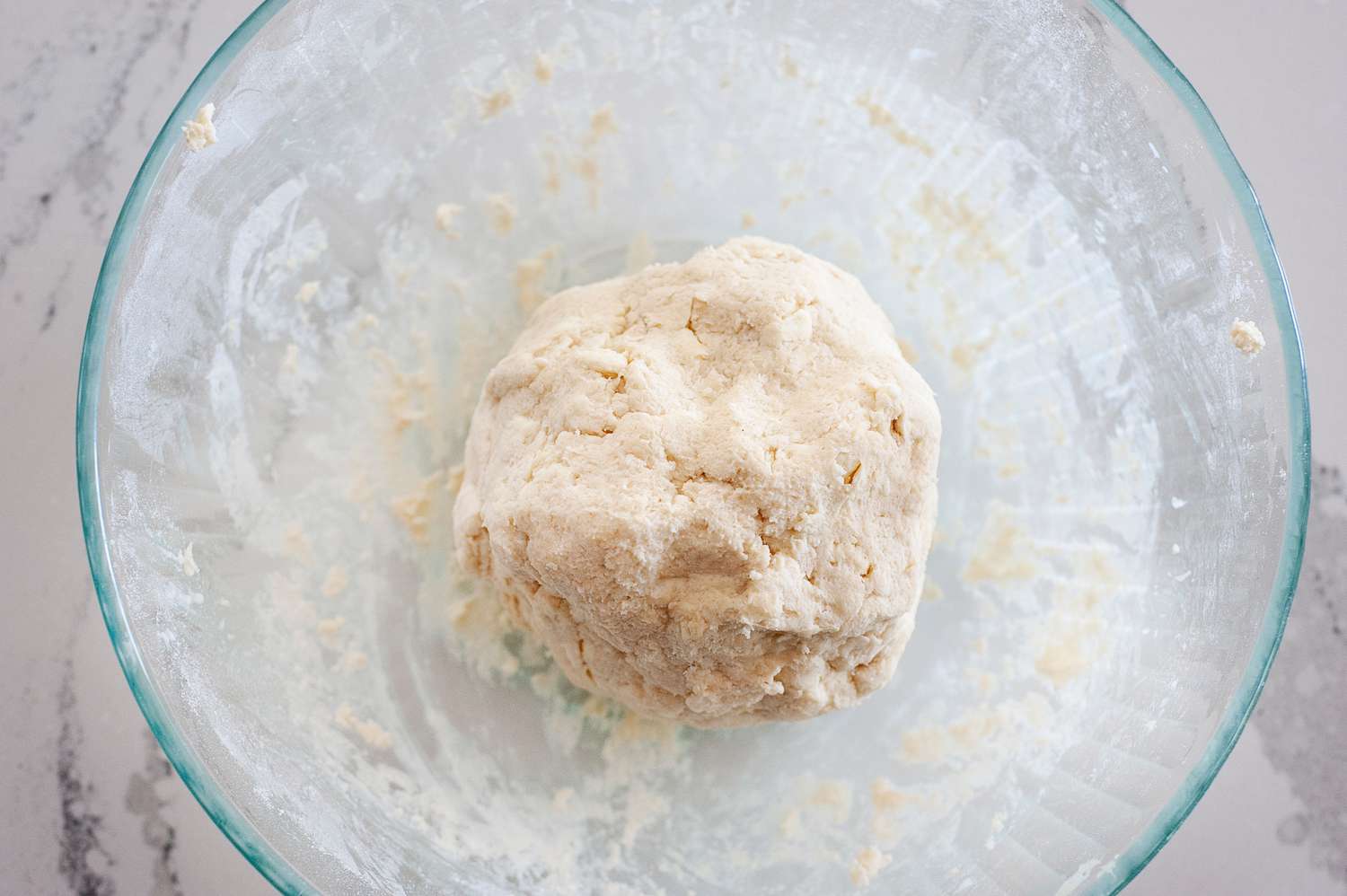Dough for the Best Basic Scone Recipe in a ball in a glass bowl.