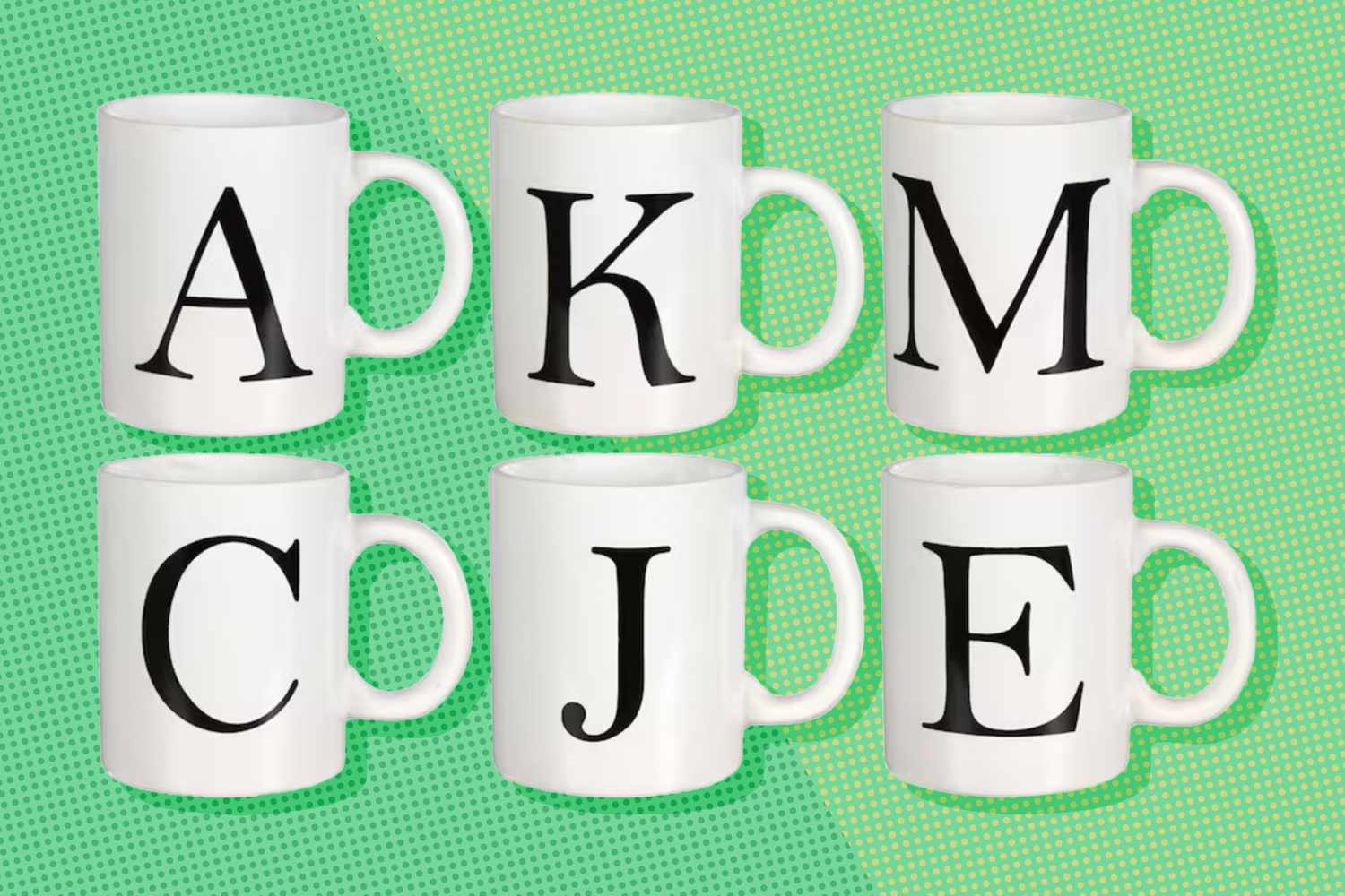 Six white mugs each featuring a bold black letter on a green background letters are A K M C J E