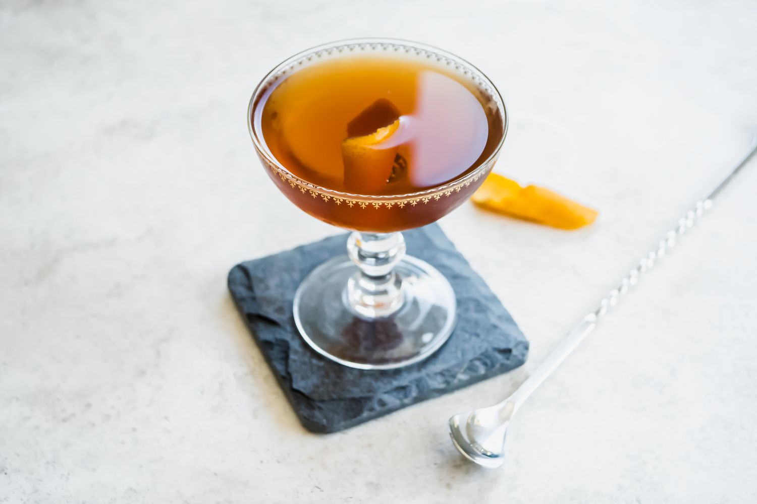 Rob Roy in Cocktail Glass on Top of Granite Coaster