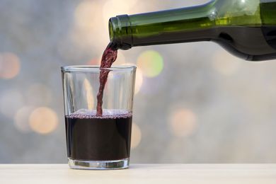 red wine pouring in cup