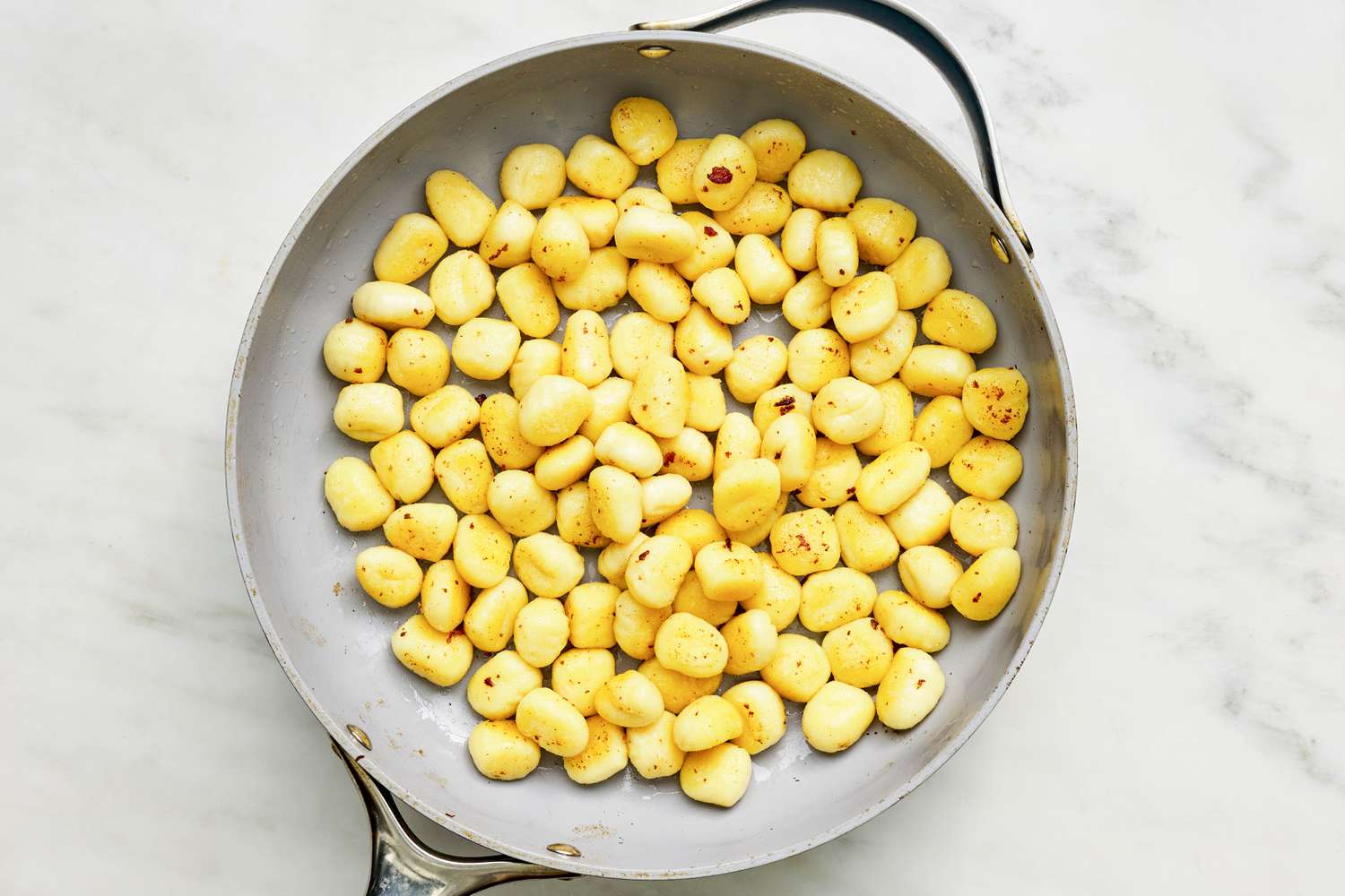 Gnocchi sauteed in skillet until crispy and light golden for Sliced bacon cooked in a skillet for Skillet Gnocchi With Bacon and Peas recipe