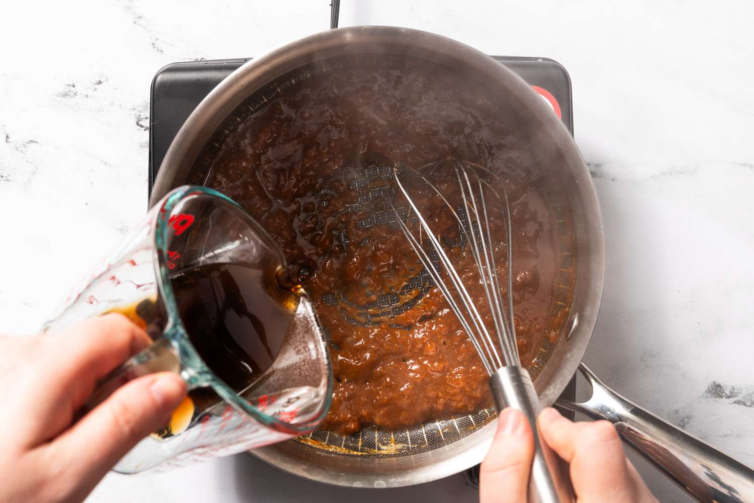 Worchestershire sauce and spices whisked into the roux in the pot for welsh rarebit recipe
