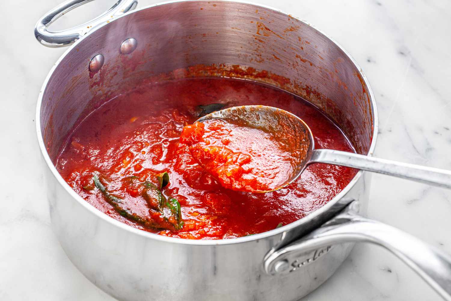 Basil Mixed Into the Pot of Homemade Marinara Sauce