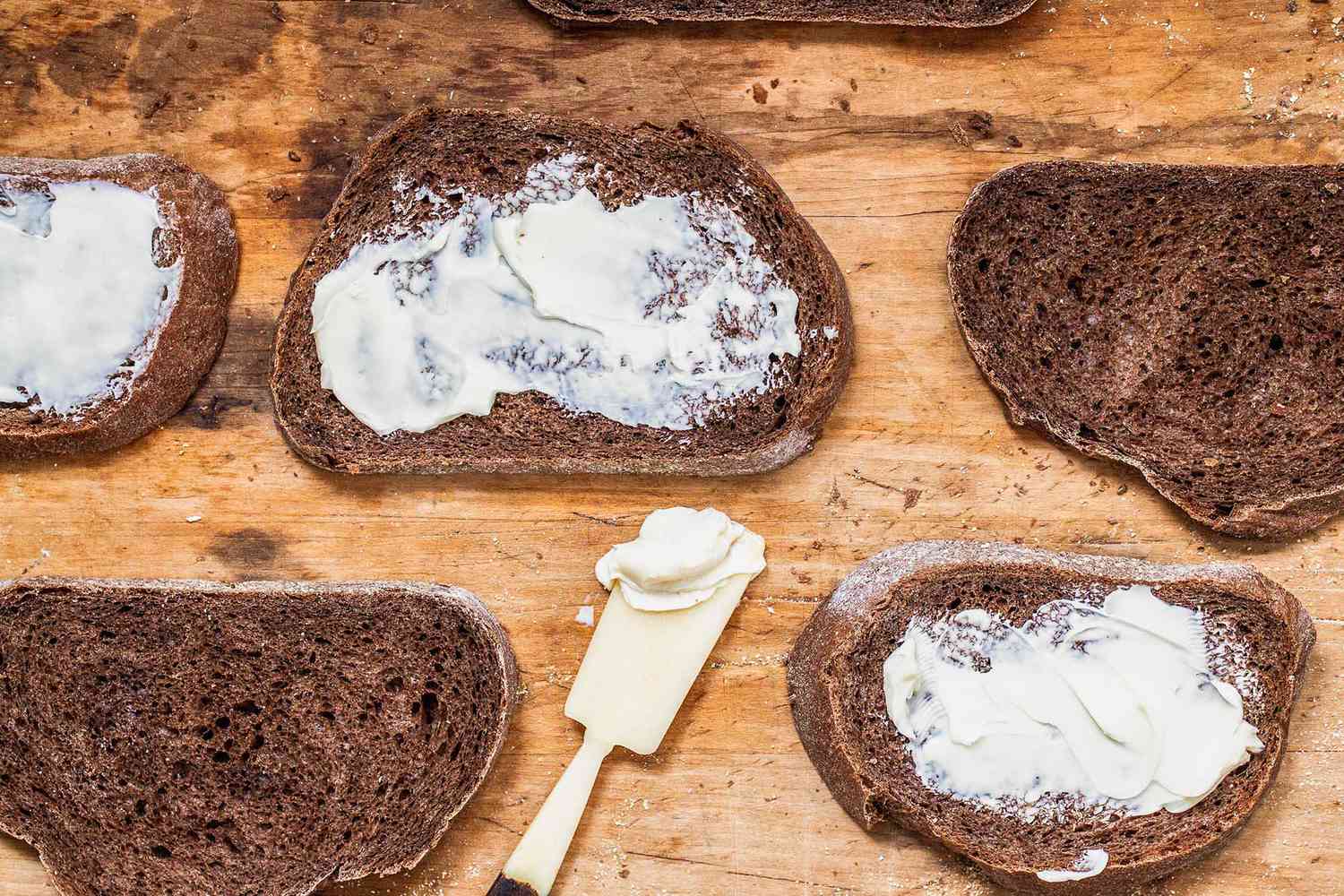 Rye bread on a counter spread with butter