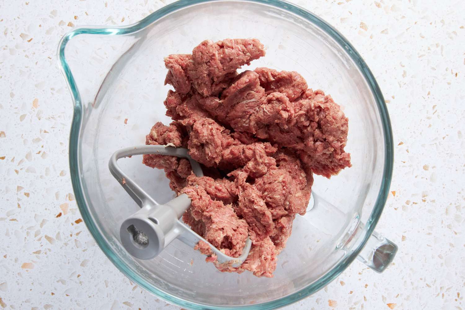 Ground Beef and Pork in Mixer Bowl With Mix Attachment After Being Mixed 