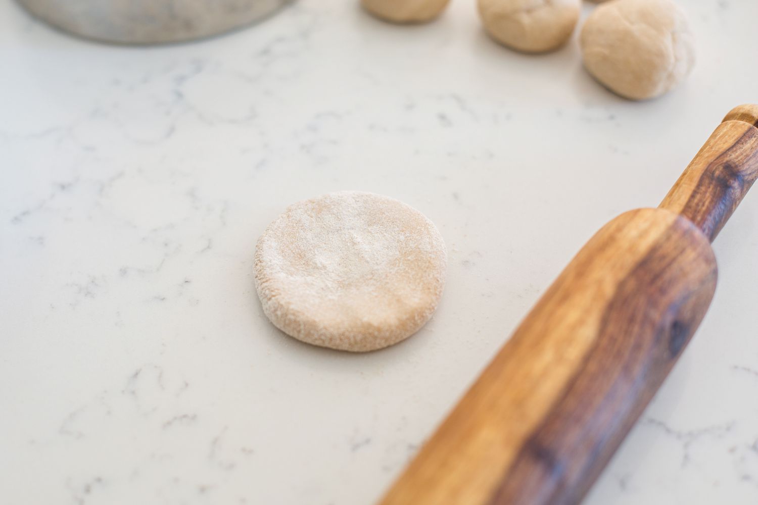 Rolling out dough to make roti.