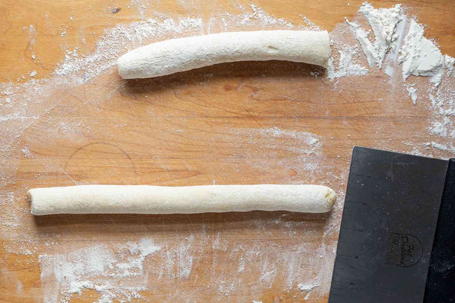 Rolling snakes of dough to make into homemade Potato Gnocchi