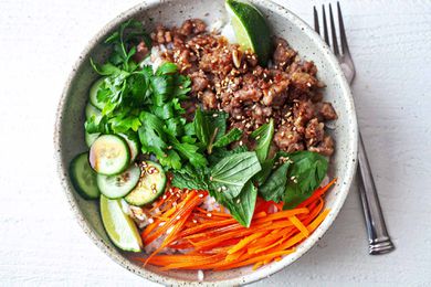how to make Pork Rice Bowl Recipe herbs in center of bowl with pork and carrots on side