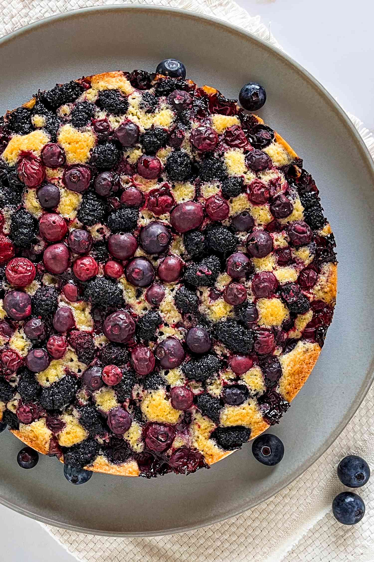 Blueberry Cake on a Plate With Rogue Blueberries