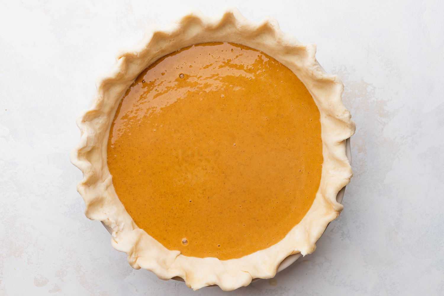 Uncooked Old Fashioned Pumpkin Pie in a Pie Pan