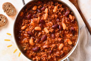 Photo of a pot of chili with yellow lined illustrations next to it
