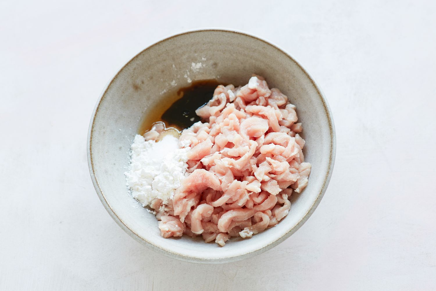 Pork filling for spring rolls in a bowl.