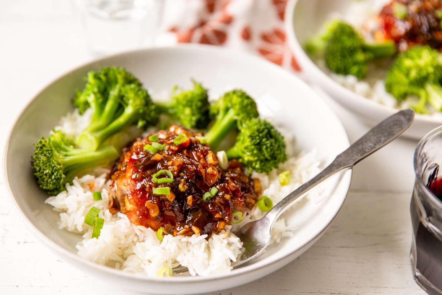 Retro Plum Jam Chicken over rice with a side of broccoli on a small plate