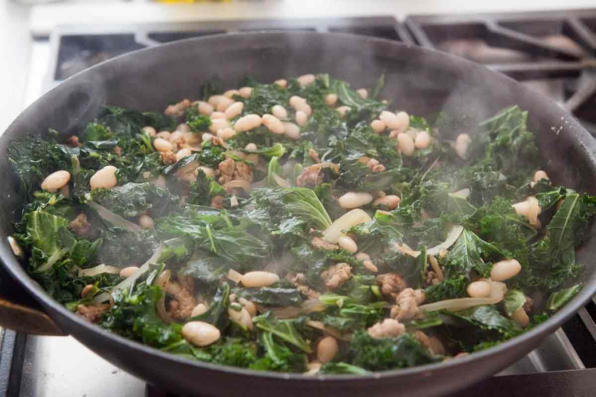 cooking kale, white beans, and sausage