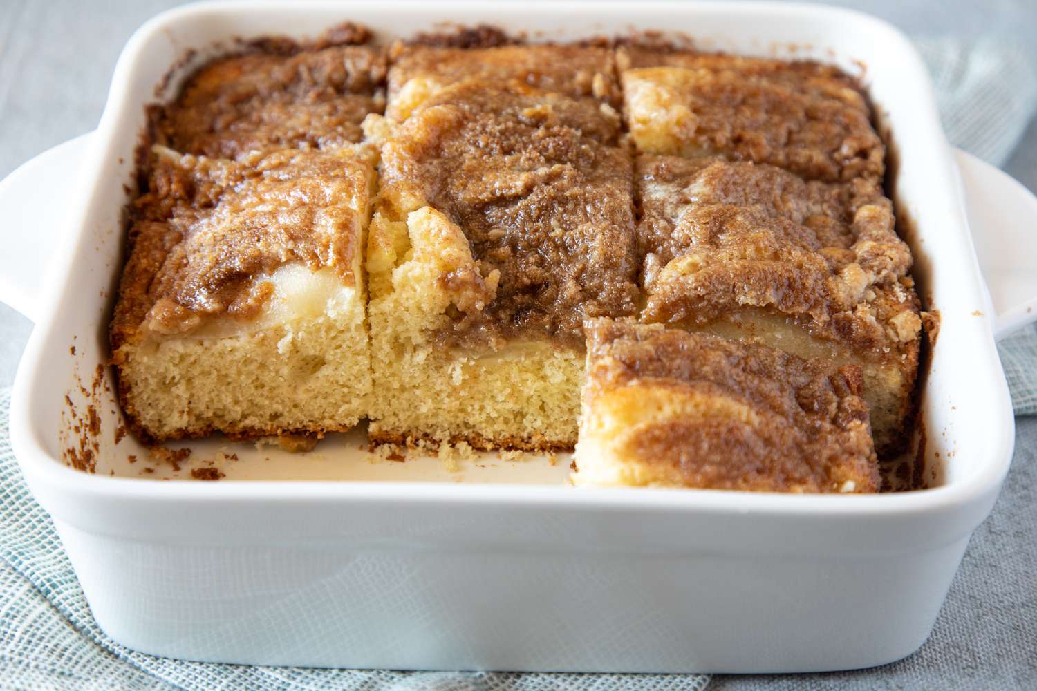 A baking pan with bisquick coffee cake and two squares removed from the pan.