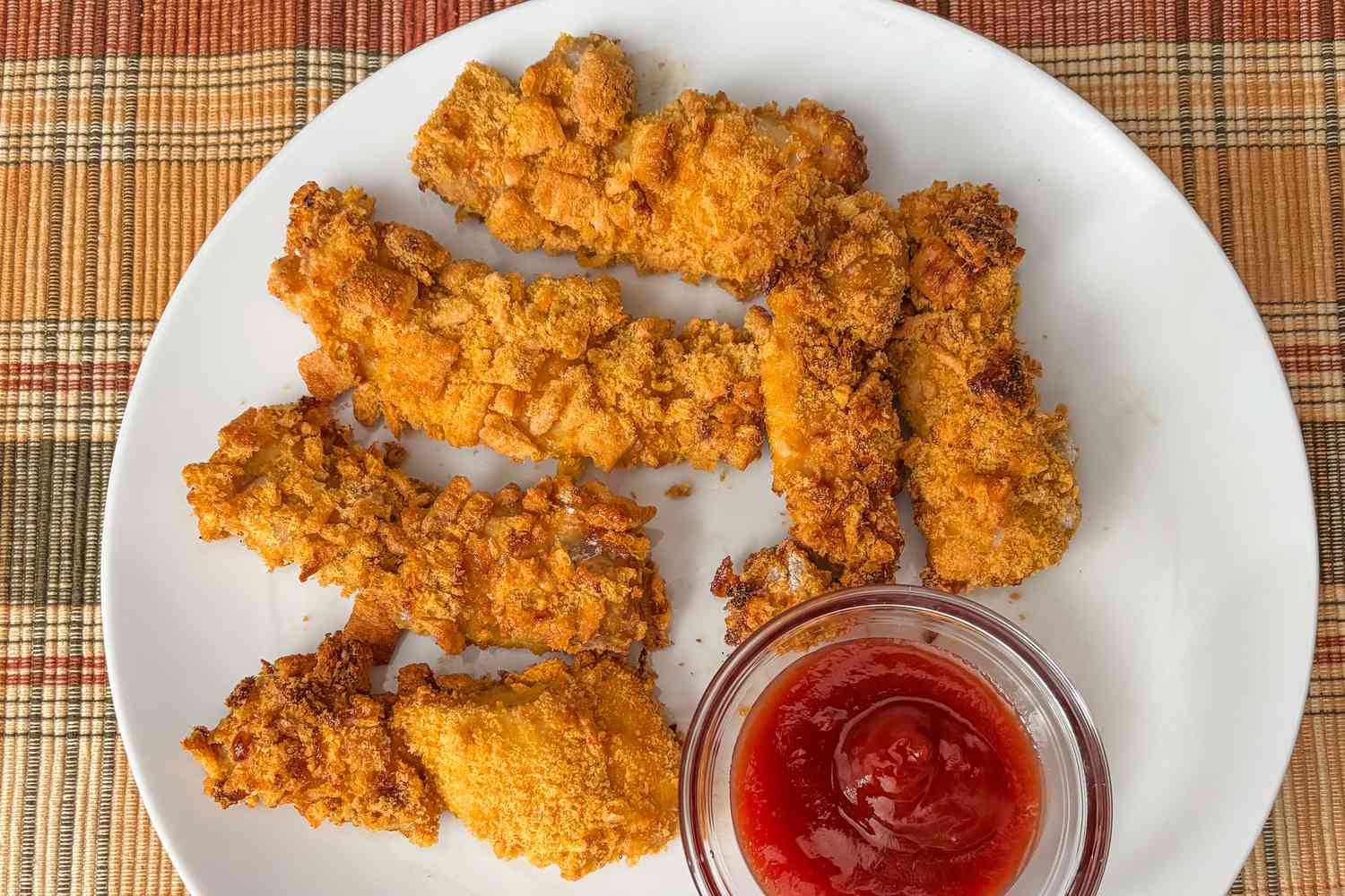Ree Drummond's 4-Ingredient Chicken Strips on a plate with a side of ketchup