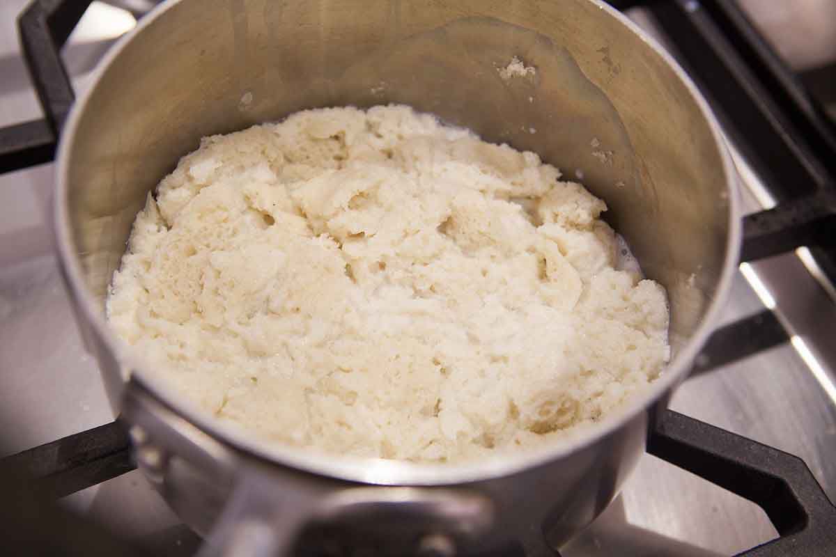 Soak the bread in hot milk in a saucepan