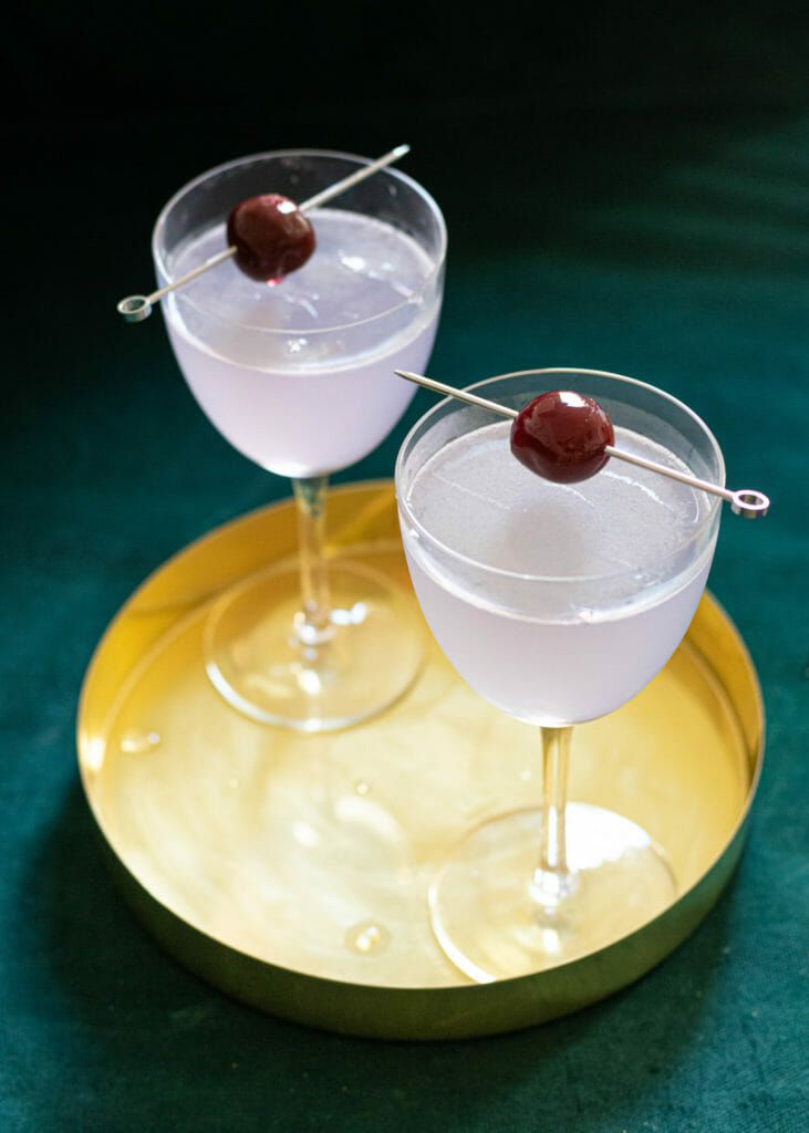 Light purple aviation cocktails on gold tray