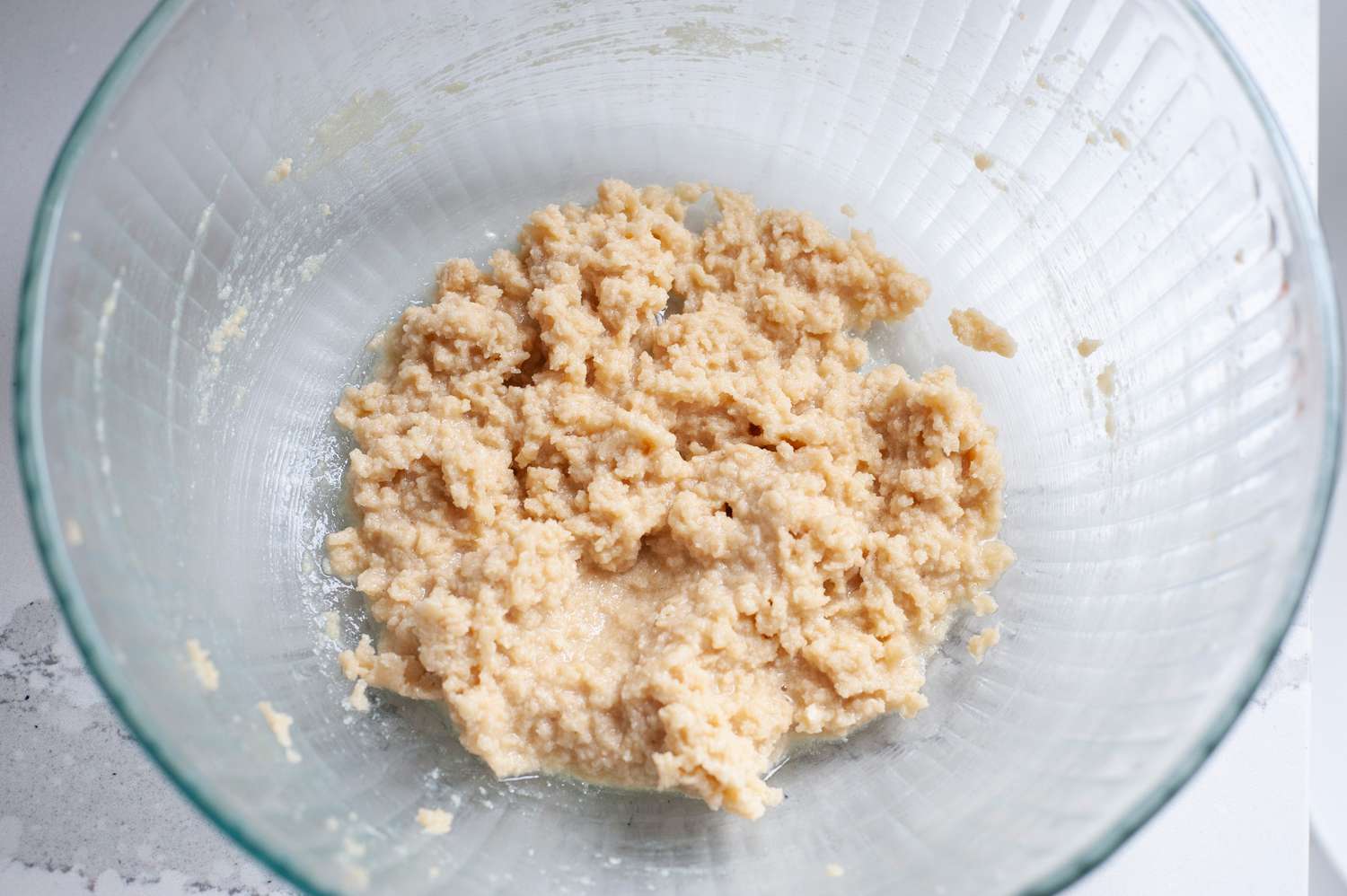 Making the dough for slice and bake sesame cookies in a glass bowl.