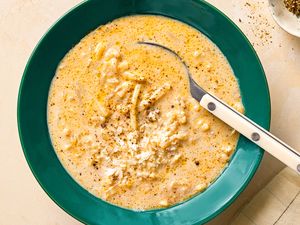 Bowl of creamy cacio e pepe potato soup with a spoon