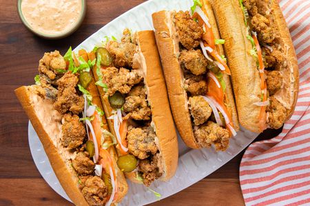 A Platter Filled with Oyster Po' Boys, Surrounded by a Kitchen Towel and a Bowl of Remoulade 