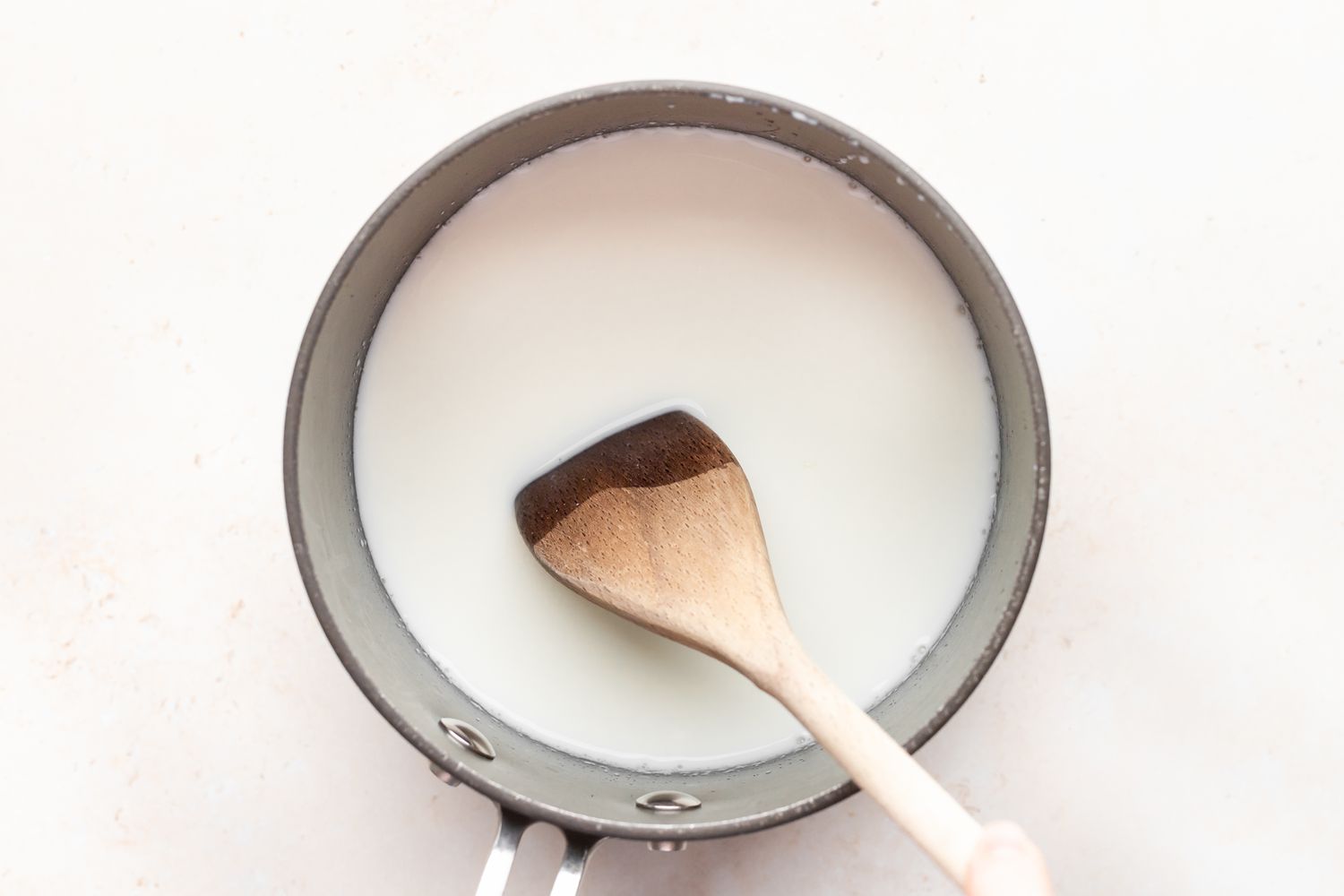 Overhead view of a pot with ingredients to make tapioca pudding.