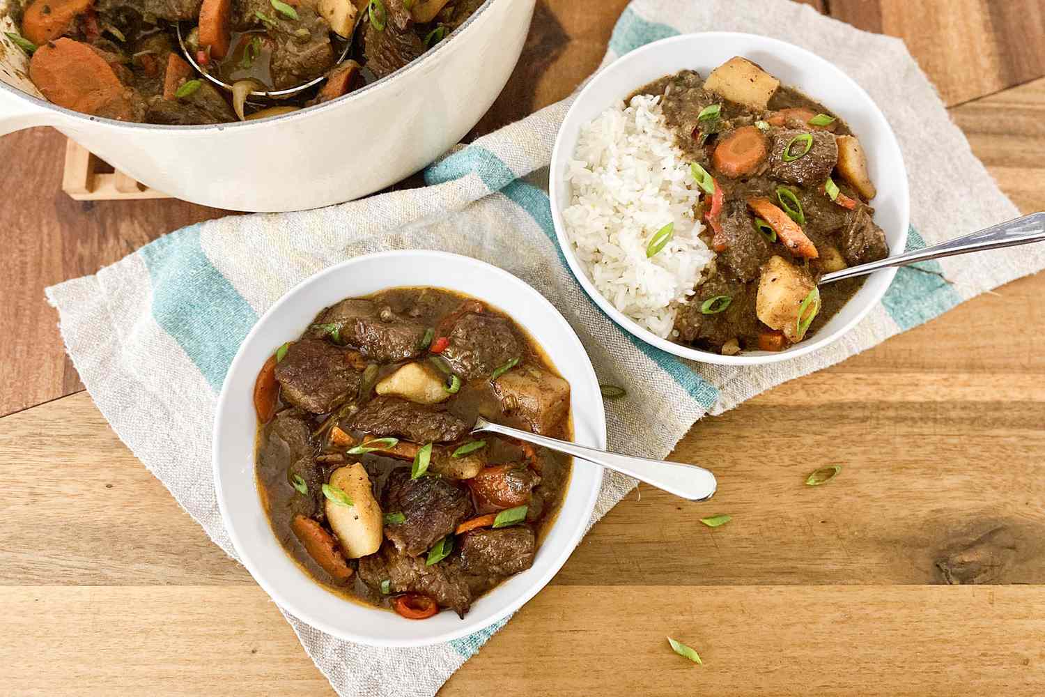 Two bowls of Jamaican Beef Stew served with rice.