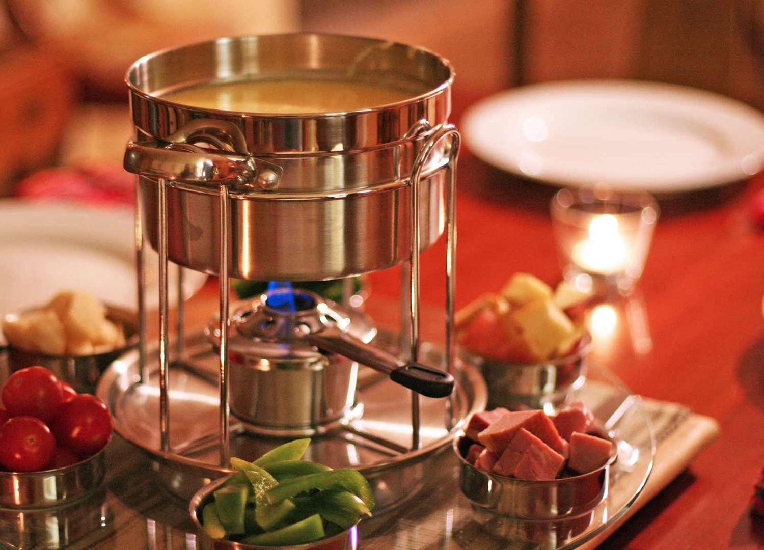 A fondue pot with cheese fondue, ready to serve