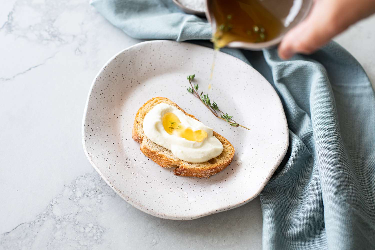Whipped Ricotta Toast with a Bowl of Lemon-Thyme Honey Drizzled onto It 