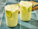 Two glasses of limonada on a tiled surface