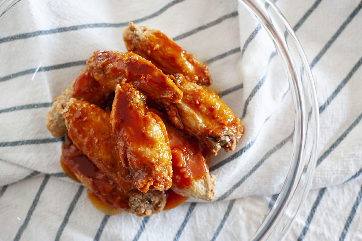 Home made Air Fryer Chicken Wings with Gochujang Sauce in a bowl.