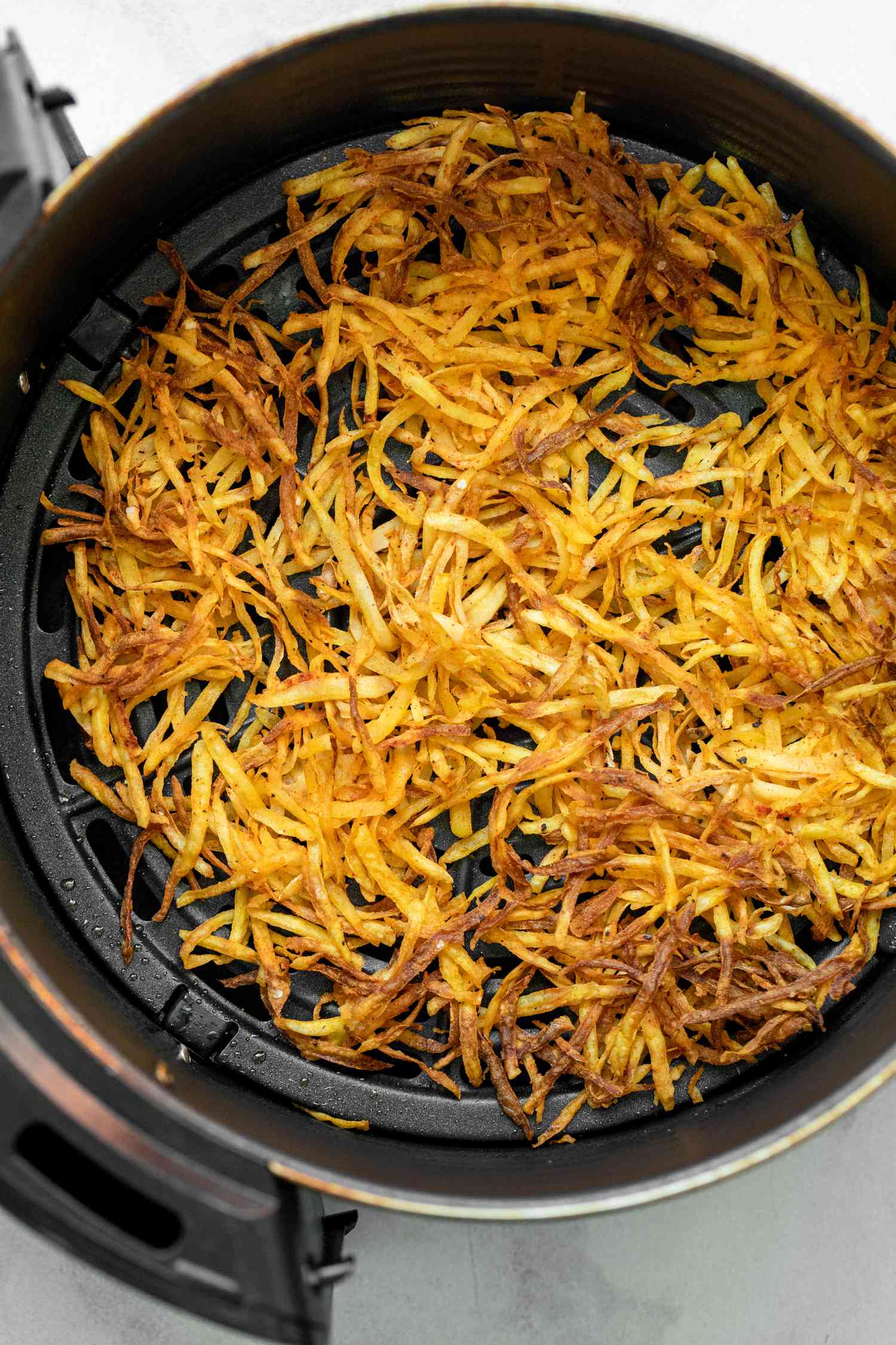 Air Fryer Hash Browns in Air Fryer Basin