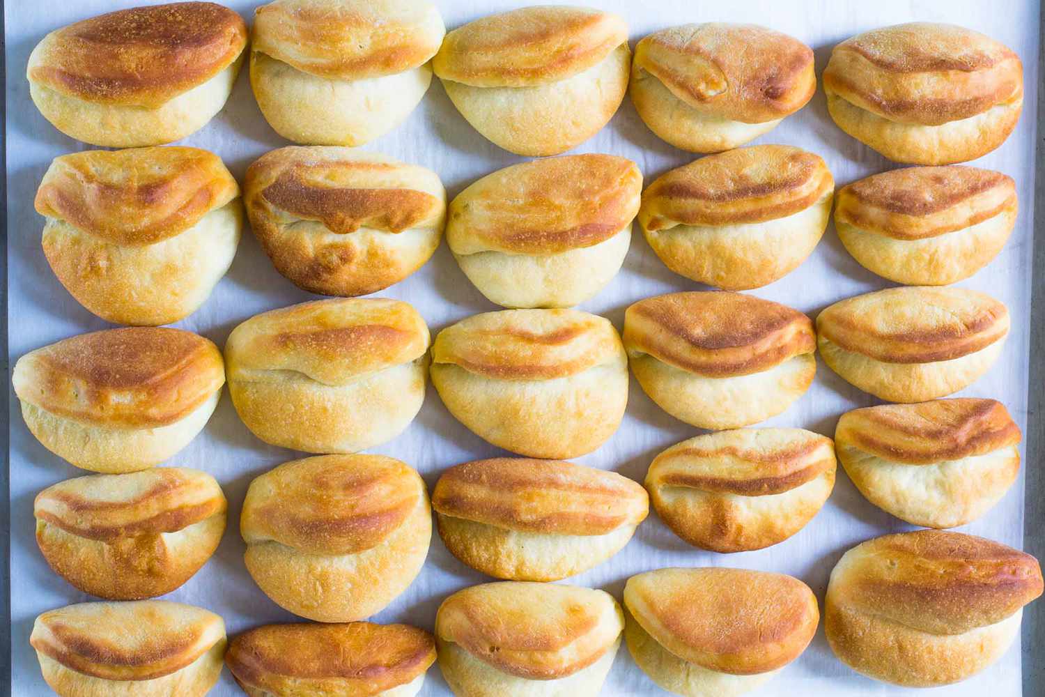 A sheet pan of baked Parker house rolls