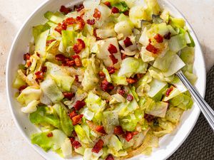 overhead view of a bowl of Southern “Fried” Cabbage with a serving spoon