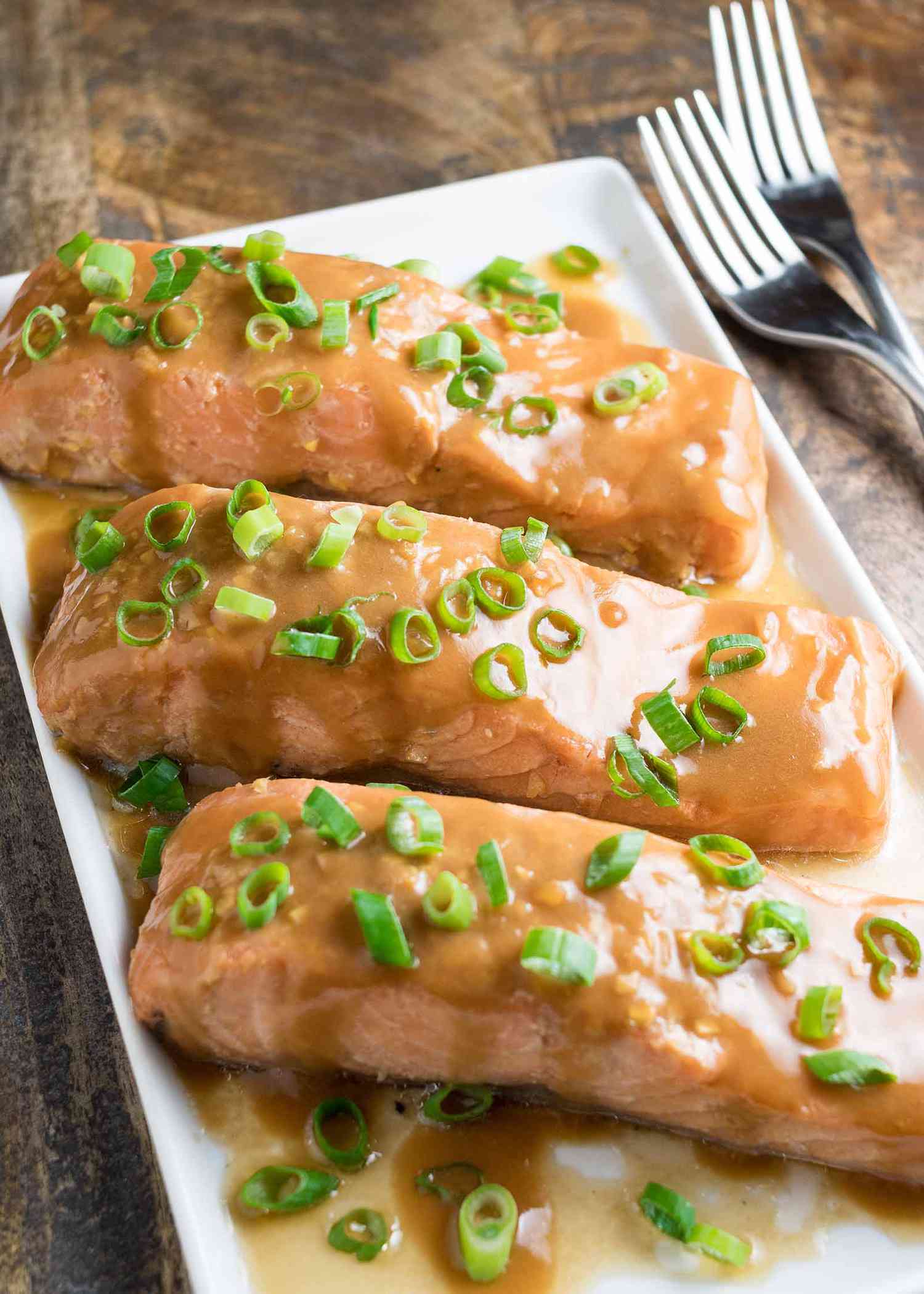 Sous Vide Teriyaki Salmon with green onions on a platter