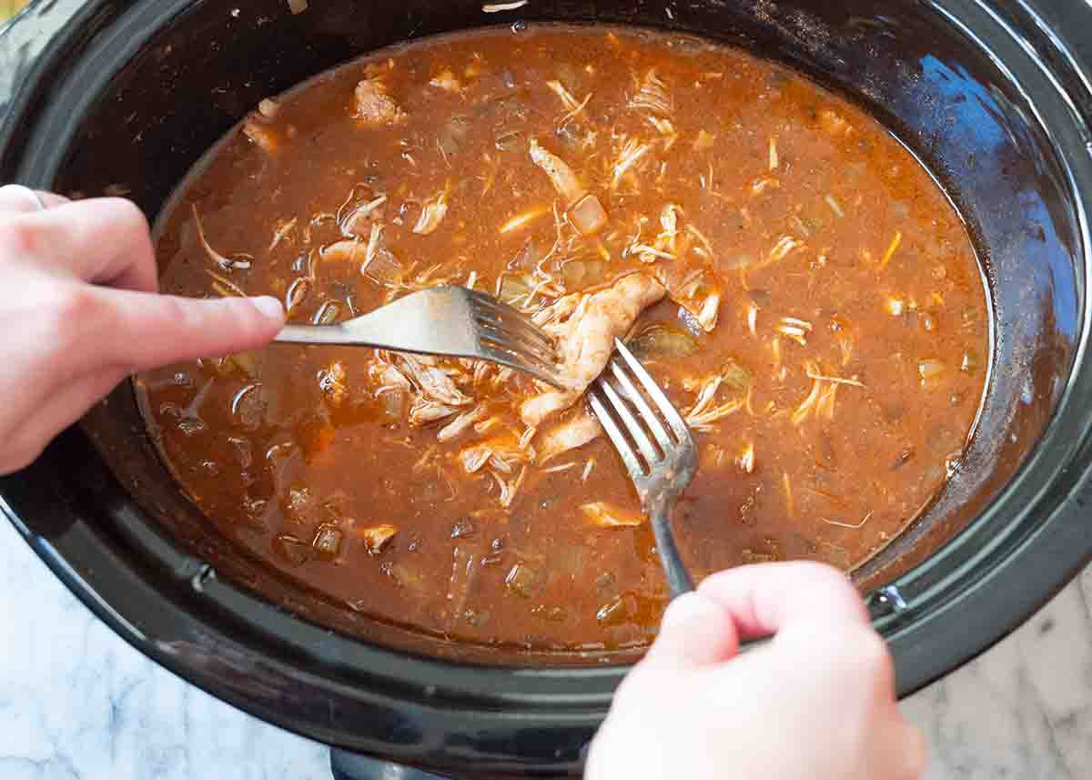 Shredding the chicken for easy crockpot chicken chili