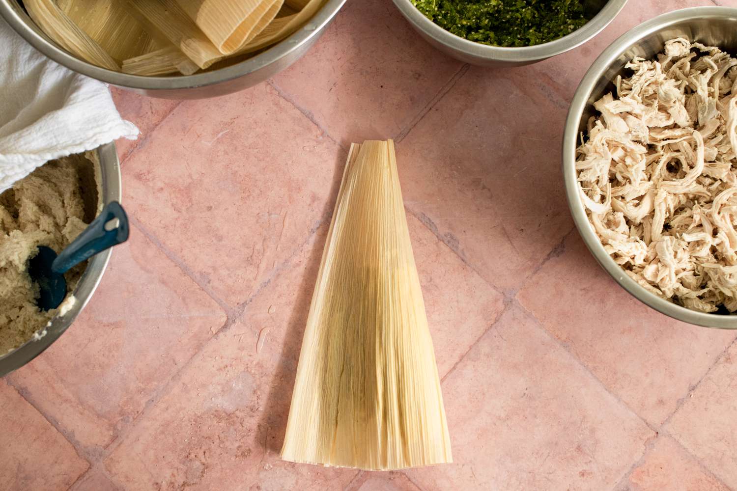 Making the Tamales the Corn Husk Folded Vertically in Half over the Fillings