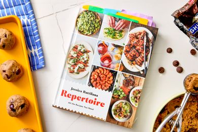 Cookbook titled Repertoire by Jessica Battilana displayed on a table with food items nearby