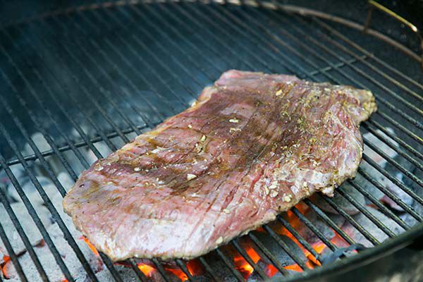 grilled flank steak on coal grill