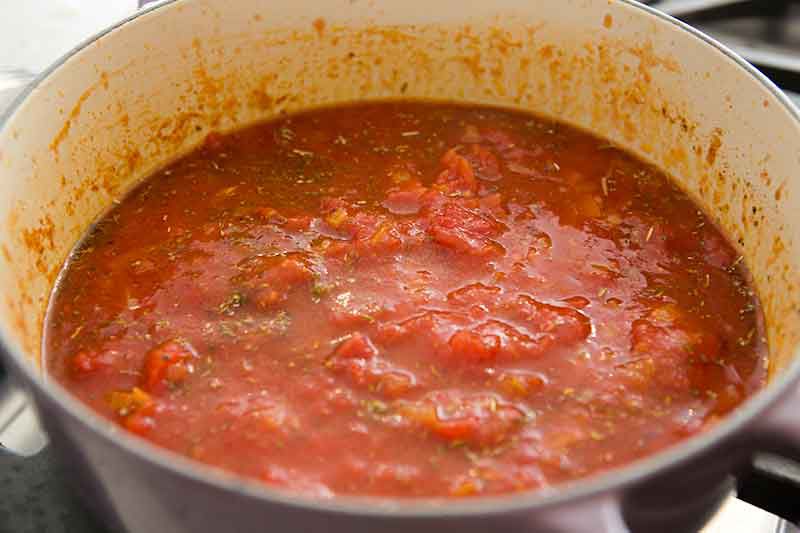 tomatoes cooking before adding roasted root vegetables