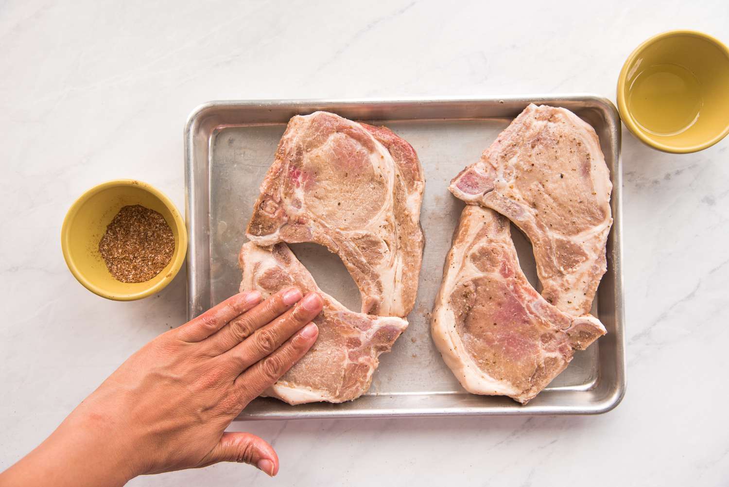 Rub Seasoning on Pork Chops in Tray 