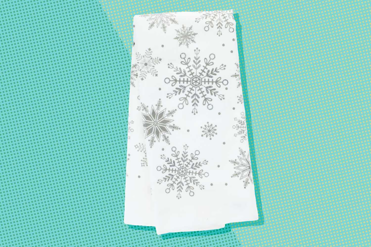 A holiday themed dish towel with snowflake patterns