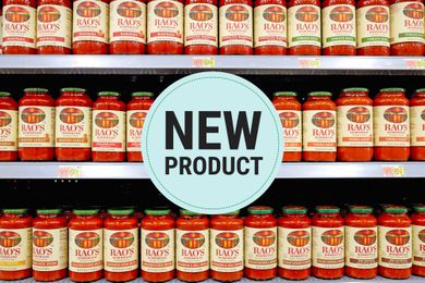 Jars of Rao's marinara sauce displayed on store shelves, a "New Product" sign in the center